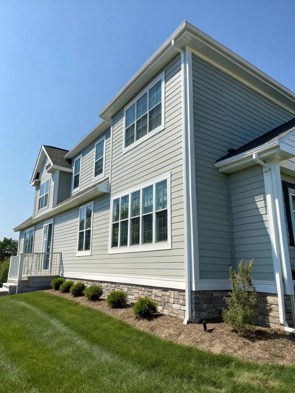 A newly constructed house with Hardie panel siding, showcasing a modern and clean aesthetic. The image should highlight the precision and quality of the siding installation.